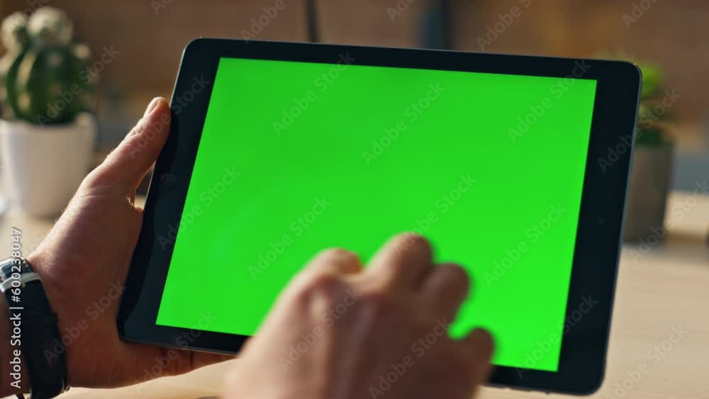 Hands touching mockup tablet searching information in internet indoors close up.