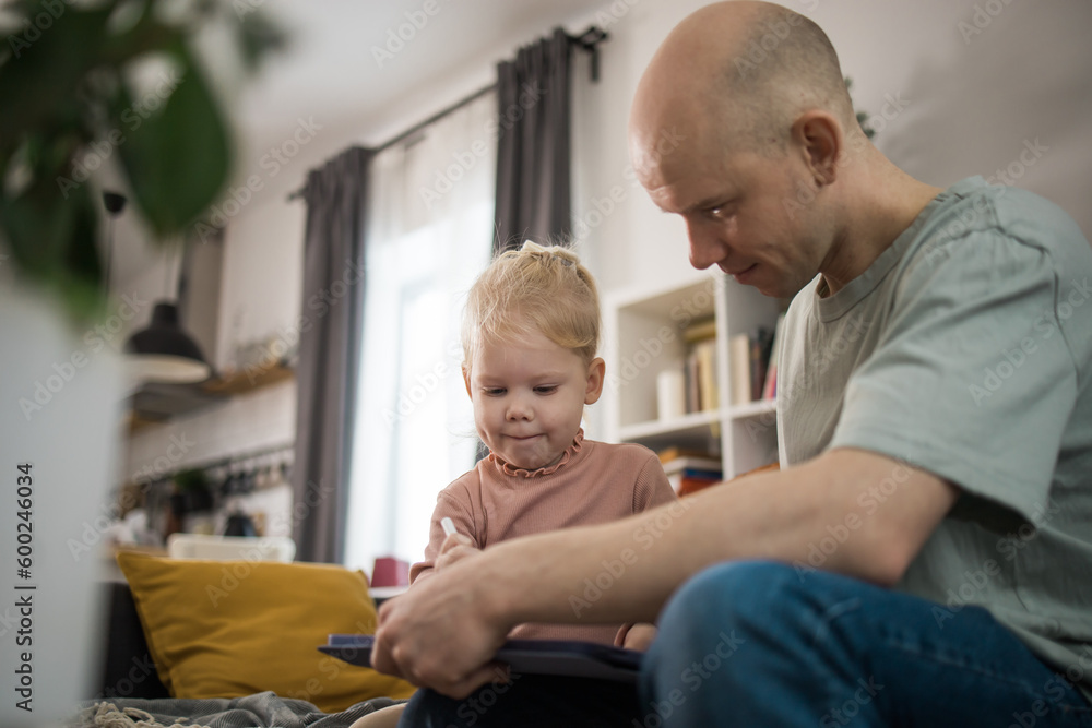 Fototapeta premium Baby with cochlear implant have fun with father. Hear aid and medicine innovating technology and diversity concept