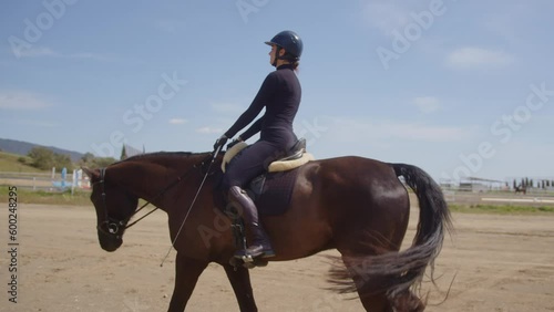 Woman riding horse in field during equine therapy session
