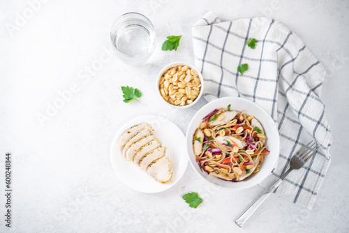 Warm backwheat pasta chicken vegetables salad with peanuts photo