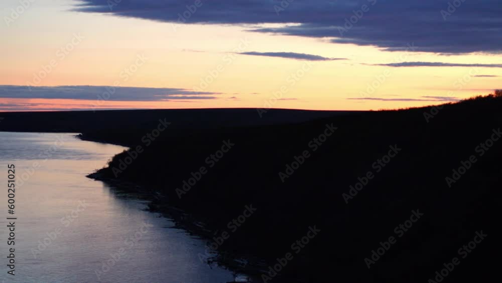 Aerial Panning Shot Of Sea By Silhouette Hill Against Orange Sky At Sunset - Bering Sea, Alaska Aerial Panning Shot Of Sea By Silhouette Hill Against Orange Sky At Sunset - Bering Sea, Alaska