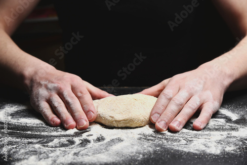Baker man hands kneading dough