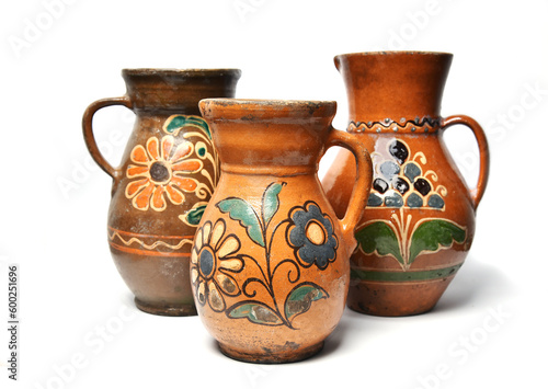 Old ceramic clay jugs on a white background.