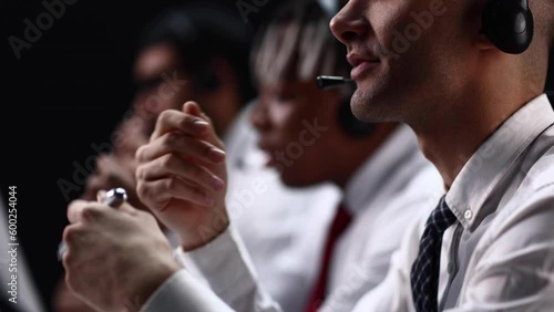 Black sales agents wearing a headset while working in a call centre