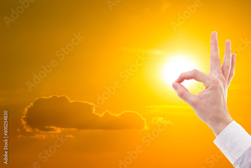 A Man's encouraging OK Sign reaches for the Heavens