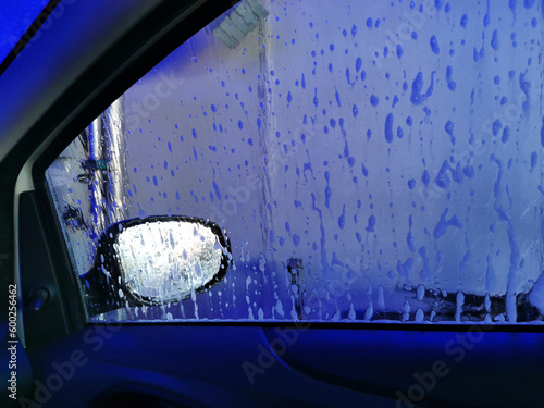 Car Care Business. Automatic Car Wash Process. Spray foam bubble shampoo on the car surface. Inside view, copy space
