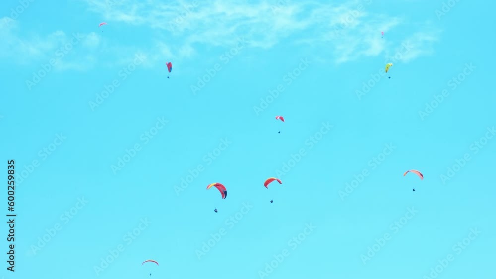 Team sport with paragliding in open sky. A sporty team practicing paragliding sport during summer vacation. Team sport with paragliding in open sky. A sporty team practicing paragliding sport during summer vacation.