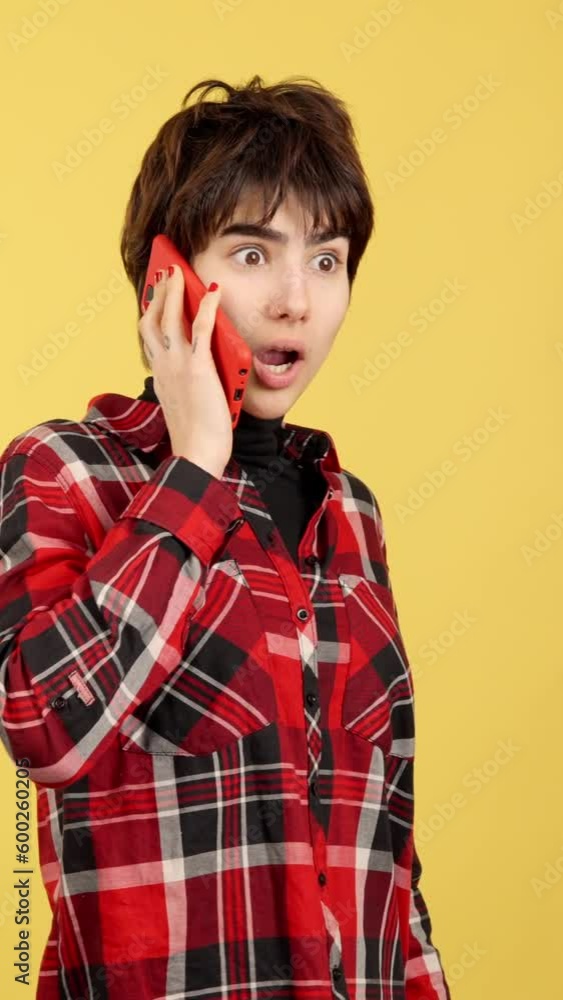 Surprised androgynous person talking to the mobile Surprised androgynous person talking to the mobile