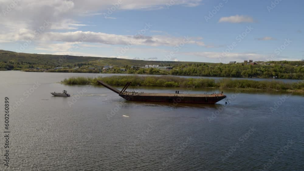 Aerial Shot Of Motorboat Pulling Abandoned Barge On Sea, Drone Ascending Backward From Boats Against Sky - Bering Sea, Alaska Aerial Shot Of Motorboat Pulling Abandoned Barge On Sea, Drone Ascending Backward From Boats Against Sky - Bering Sea, Alaska