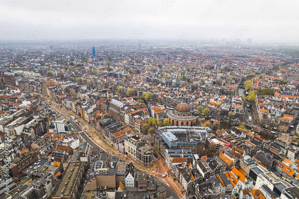 Amsterdam Center, scenic drone shot. Encounter charming cobbled streets, high-end shopping areas, renowned cultural attractions, sprawling market squares and lively entertainment areas packed with