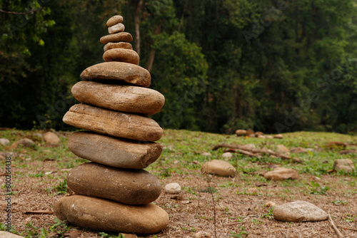 The pebbles stones are stacked in a pyramid against the natural background  The concept of harmony of balance and meditation