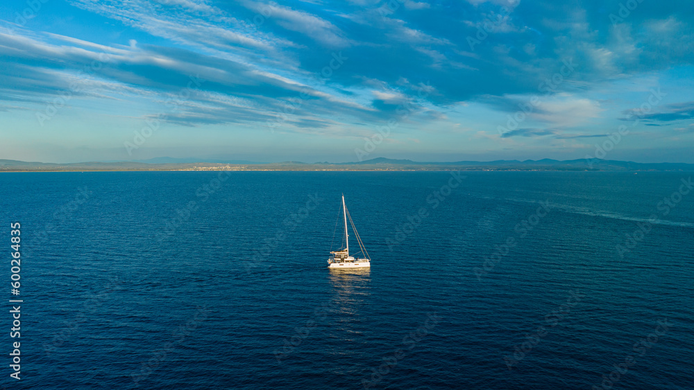 Boat moving on the sea. Sailing boat on the sea at sunset