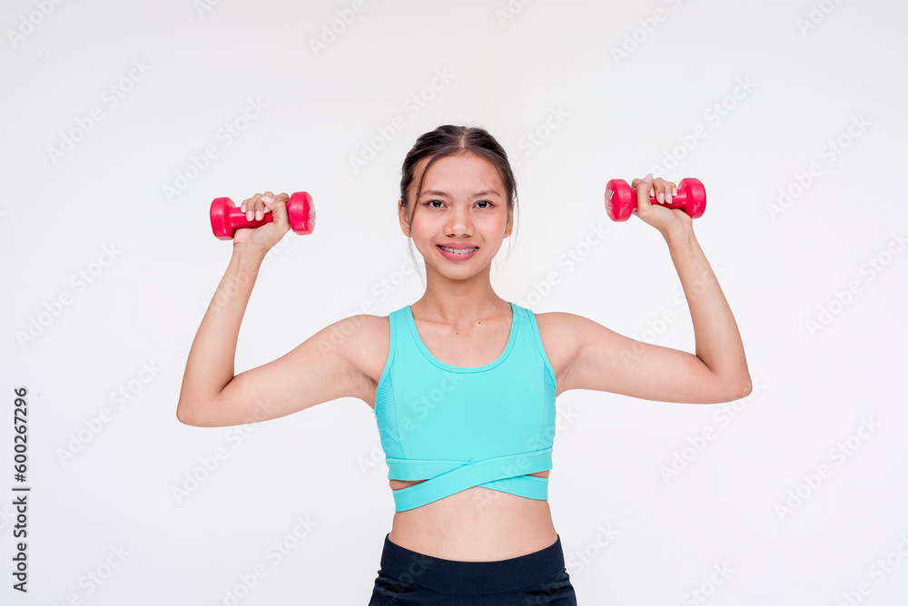 A healthy and joyful woman weightlifting and working out using a dumbbell, side view. Isolated on a white background. A healthy and joyful woman weightlifting and working out using a dumbbell, side view. Isolated on a white background.