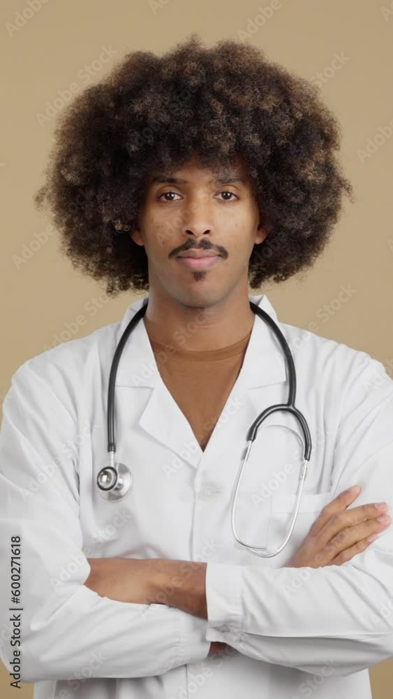 Serious african doctor looking at the camera with arms crossed Serious african doctor looking at the camera with arms crossed