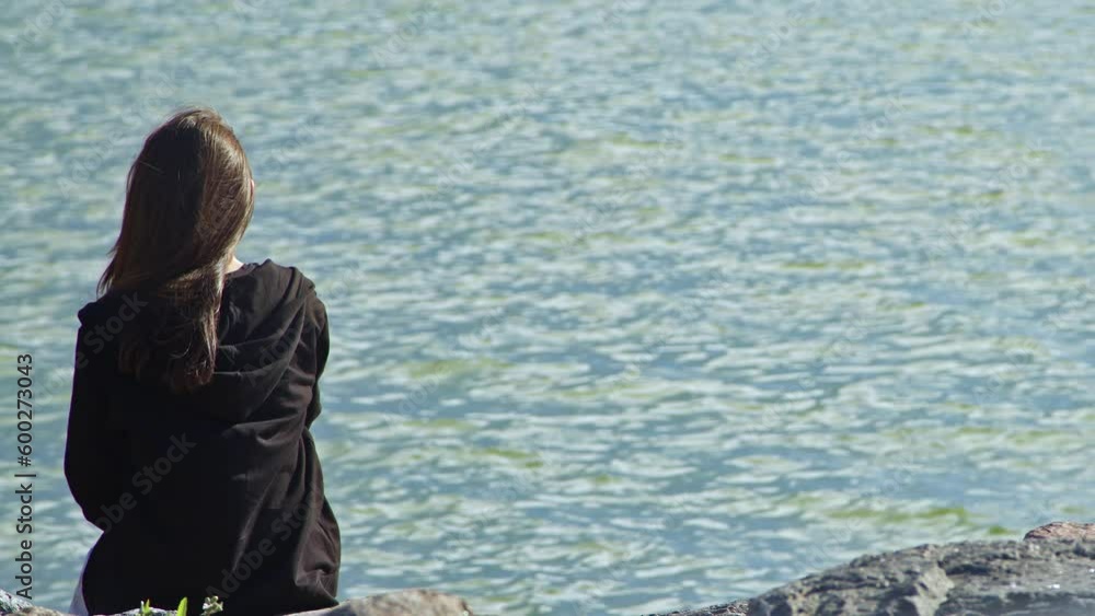 Long Brown Haired Young Woman Looking Sea on Cliffs by the Sea Footage. Long Brown Haired Young Woman Looking Sea on Cliffs by the Sea Footage.