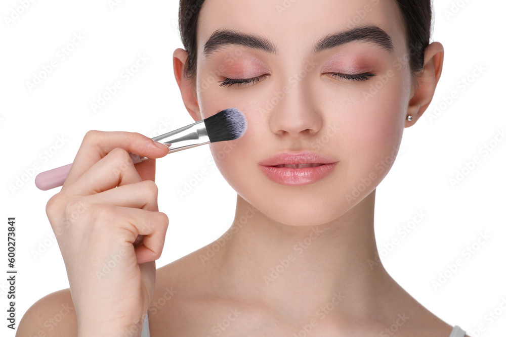 Teenage girl with makeup brush on white background