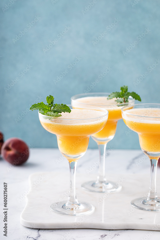 Frozen peach margaritas in three glasses with mint Frozen peach margaritas in three glasses with mint