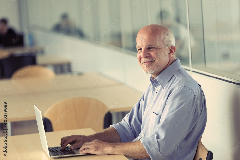 Elderly gentleman makes funny faces using a laptop Elderly gentleman makes funny faces using a laptop