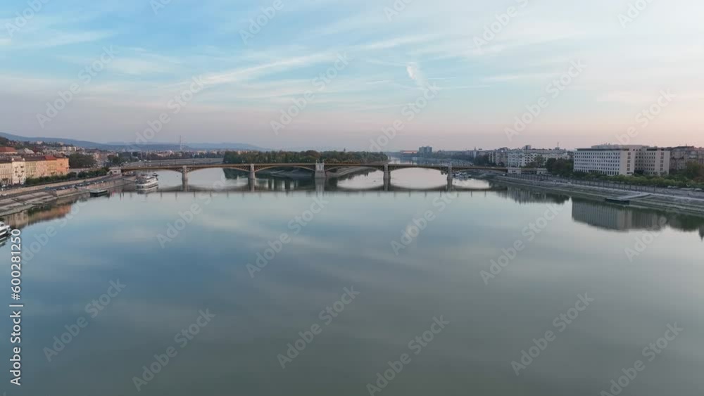 Establishing Aerial View Shot of Budapest, Hungary at sunrise. Margaret Bridge or Margit hid over River Danube, embankment. Public transport in the city Establishing Aerial View Shot of Budapest, Hungary at sunrise. Margaret Bridge or Margit hid over River Danube, embankment. Public transport in the city