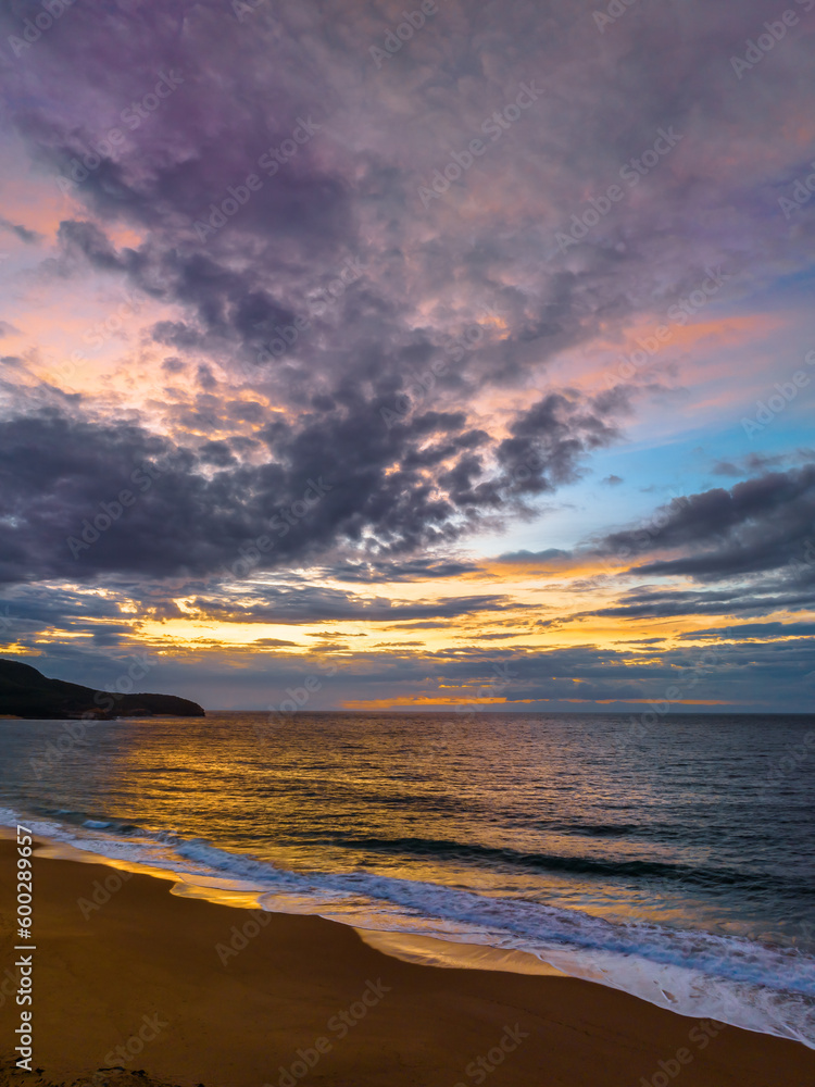 Fototapeta premium Sunrise seascape with clouds and gentle surf