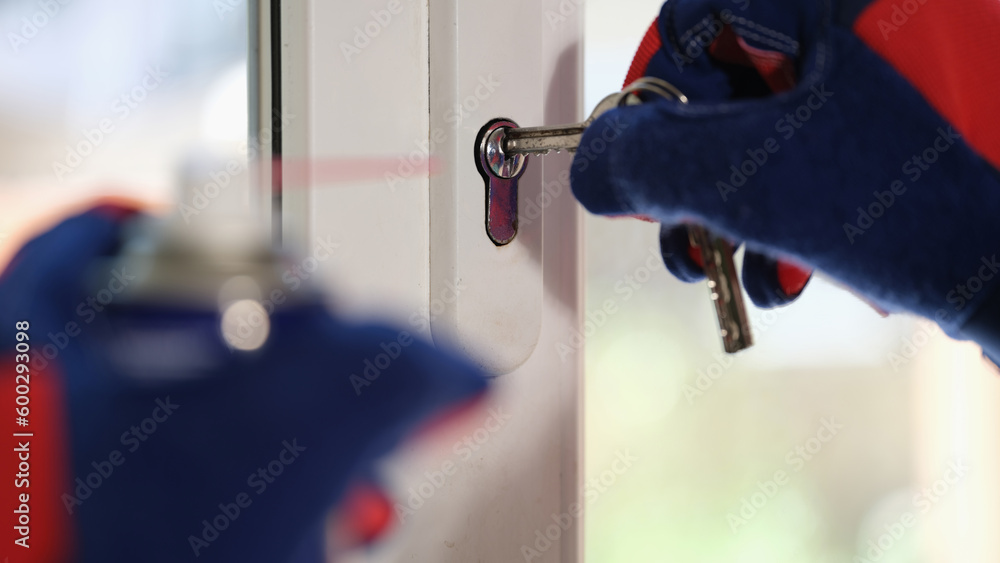 Master in gloves checking pvc windows locks with keys - obrazy, fototapety, plakaty 
