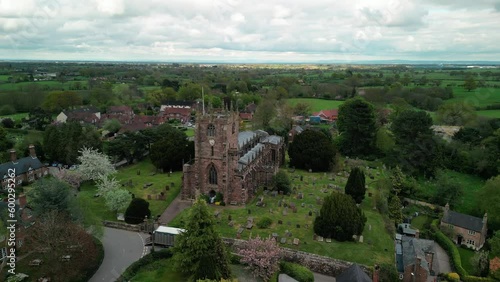 St Boniface, Bunbury, Cheshire - a quintessential English village Church - Aerial drone clockwise fast pan, May 23 photo