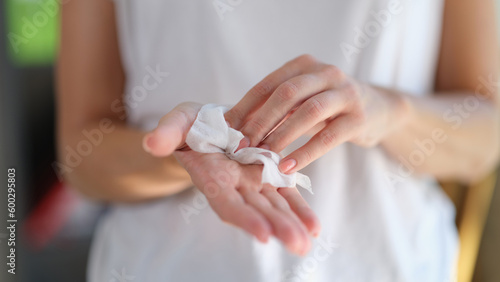 Woman cleaning hands using antiseptic wipes, hand hygiene