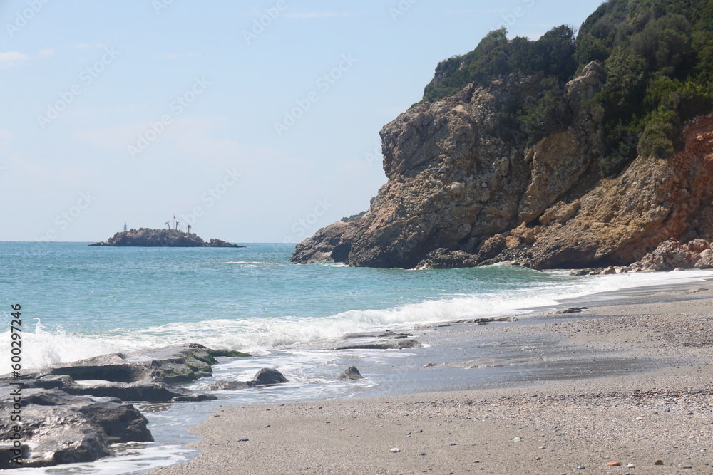 Rocky sea beach on a sunny day in Alanya, Turkiye, May 2023. Rocky sea beach on a sunny day in Alanya, Turkiye, May 2023.