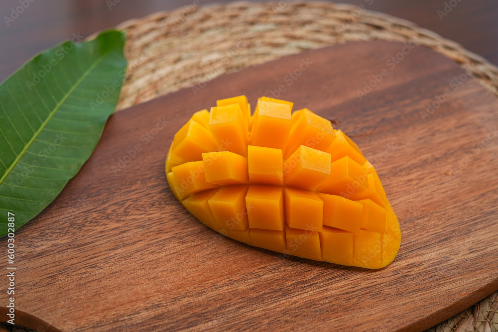 Ripe mango on wood,Ripe Mango Slice on wooden cutting board Ripe mango on wood,Ripe Mango Slice on wooden cutting board
