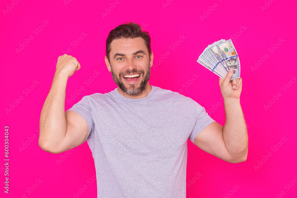 Business man hold money on pink studio isolated background. Rich man in t-shirt with money dollar bills. Successful businessman with dollar banknotes. Rich man holding money. Business man hold money on pink studio isolated background. Rich man in t-shirt with money dollar bills. Successful businessman with dollar banknotes. Rich man holding money.