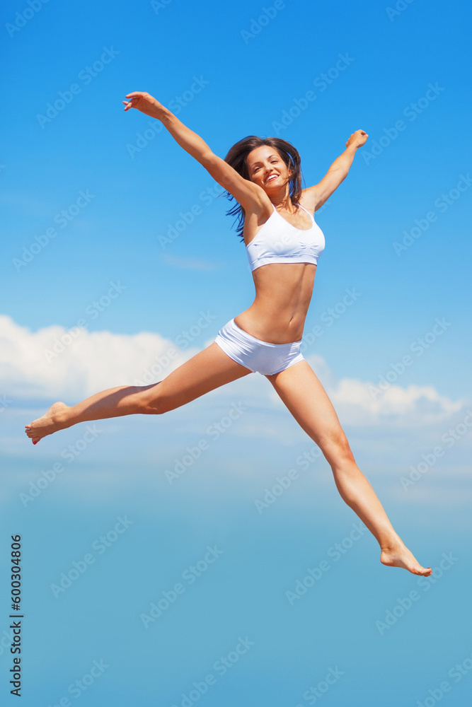 Freedom, portrait and body of woman jump in underwear on blue sky background with energy, happy or mockup. Smile, jumping and girl model in air in celebration, health or achievement and summer fun Freedom, portrait and body of woman jump in underwear on blue sky background with energy, happy or mockup. Smile, jumping and girl model in air in celebration, health or achievement and summer fun