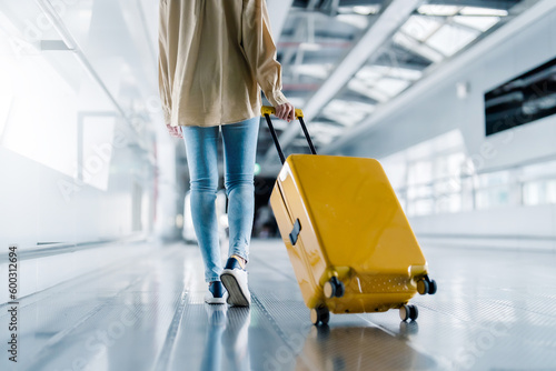 International airport terminal. Asian beautiful woman with luggage and walking in airport