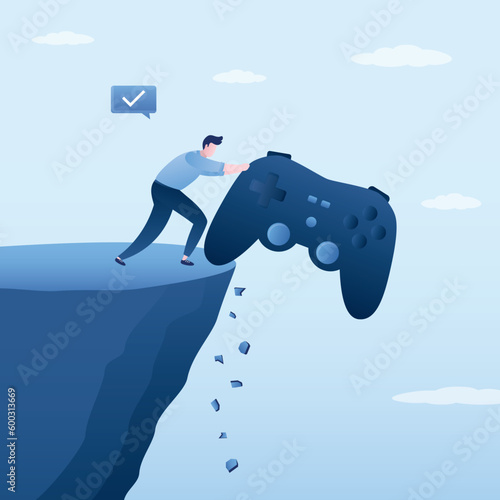 Male player pushes big joystick off cliff into an abyss. Freedom, life without gambling addiction. Gamer guy is not dependence to  cybersport. Problem of addiction to esports and online games.