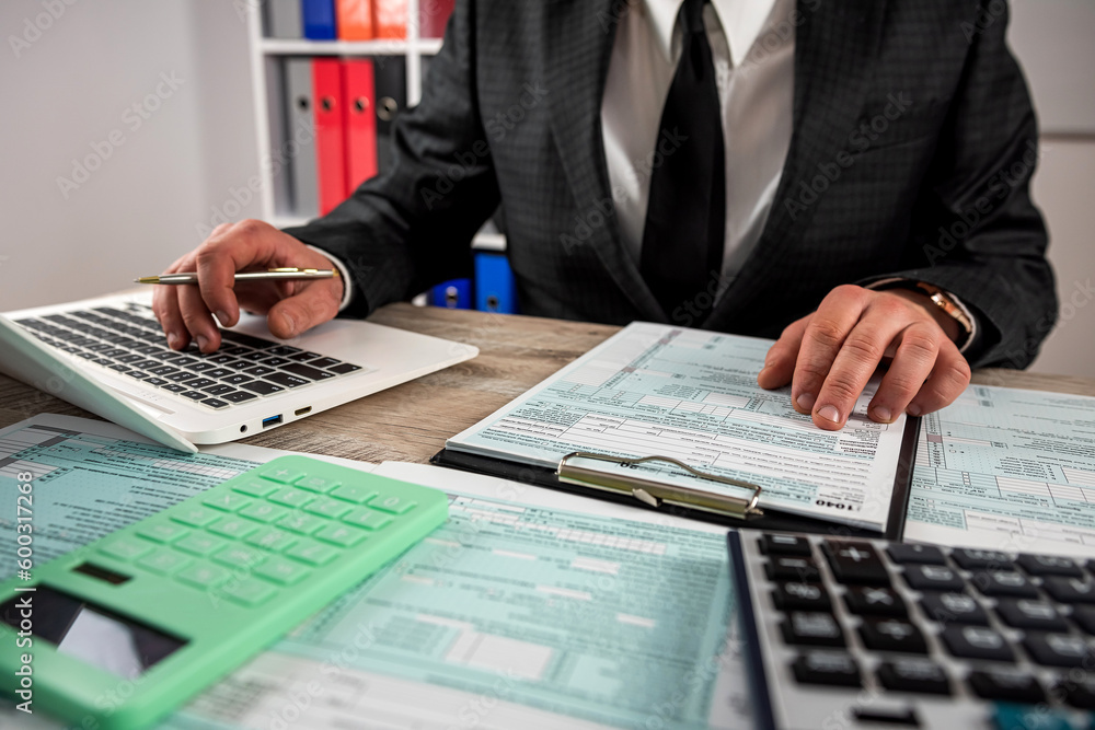 closeup male hand filling finance report document tax form closeup male hand filling finance report document tax form