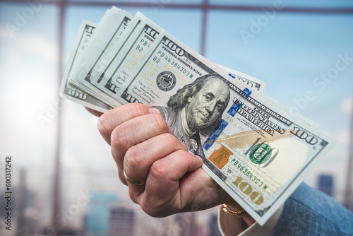 Hands of businessman holding us dollar bills close up, investment