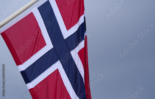 The national flag of Norway waving against cloudy sky. Concept image for Kingdom of Norway.