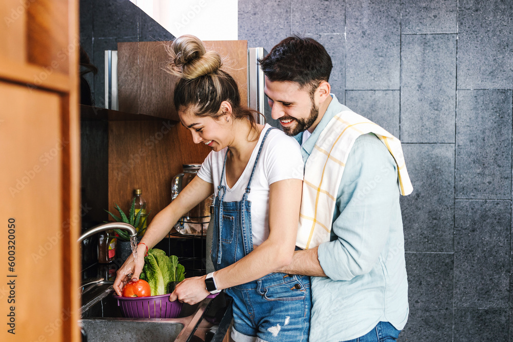 Φωτογραφία young latin couple cooking together in the kitchen healthy food at home in Mexic