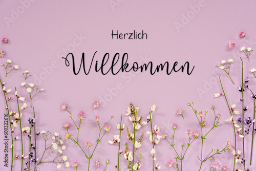 Purple Spring Flower Arrangement, German Text Herzlich Willkommen Means Welcome