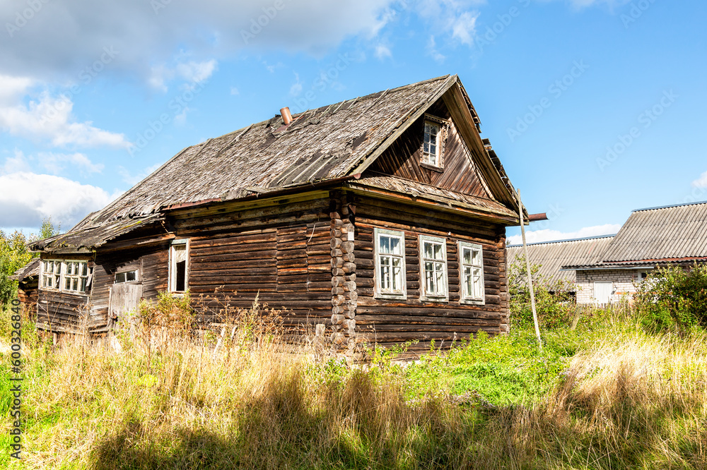 Old abandoned rural wooden house in russian village in summer sunny day