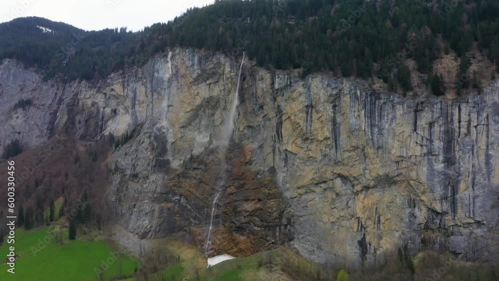 Aerial, Lauterbrunnen in Switzerland, famous Swiss alpine village landscape with Staubbach waterfall at sunrise Aerial, Lauterbrunnen in Switzerland, famous Swiss alpine village landscape with Staubbach waterfall at sunrise