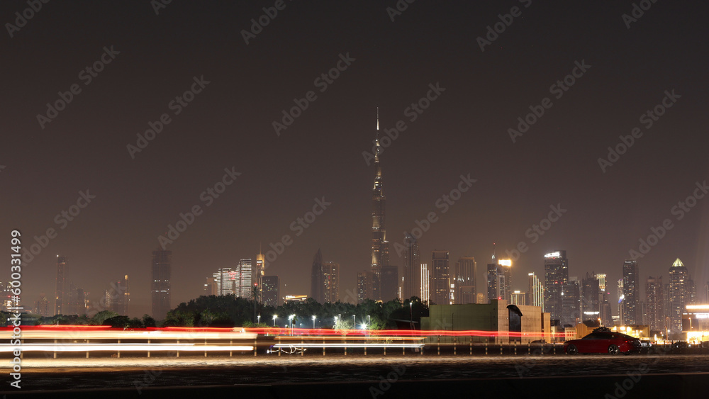 Skyline view of the Dubai city and light trails of moving cars