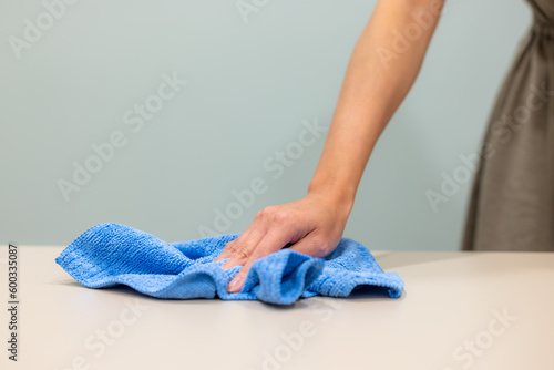 Housewife clean the table with rag