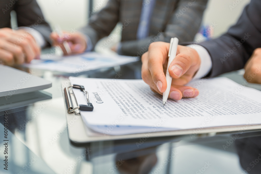 Business people read new important contract Business people read new important contract