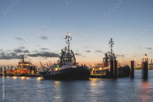 Germany, Hamburg, Boats moored in harbor at dawn photo