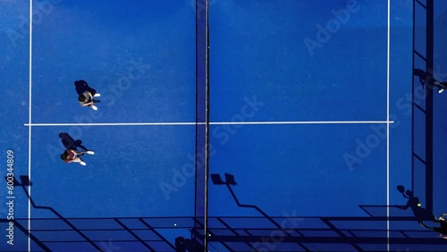 Aerial top view shot of padel tennis players playing on the court in summer. Competition of padel tennis.