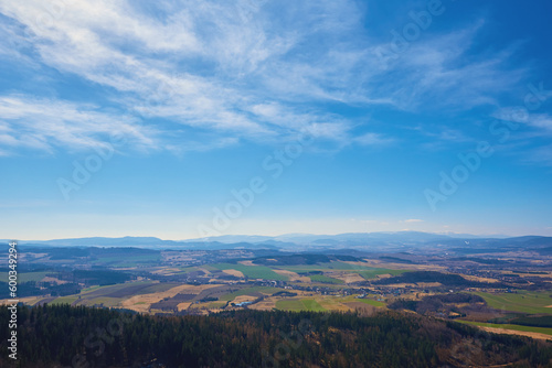 Beautiful mountains covered with evergreen forest on sunny day. Natural landscape with mountain ranges and valleys © Lazy_Bear