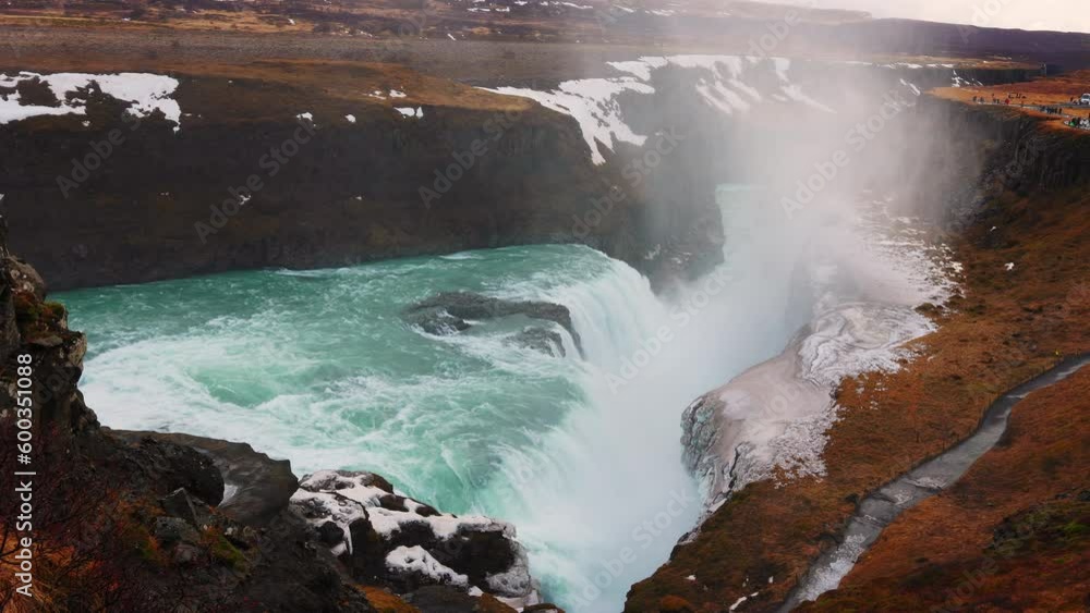 Gullfoss waterfall in iceland with spectacular water stream and wild reykjavik scenery. Cascade with river flowing near snowy cliffs, scandinavian landscapes. Handheld shot. Gullfoss waterfall in iceland with spectacular water stream and wild reykjavik scenery. Cascade with river flowing near snowy cliffs, scandinavian landscapes. Handheld shot.