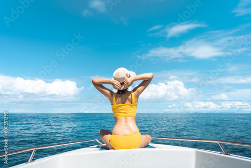 Rear view of tourist woman sit on the sailing boat luxury travel southeast asia on summer vacations