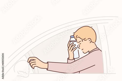 Man driver feels headache putting water bottle to forehead and closes eyes sitting behind wheel car