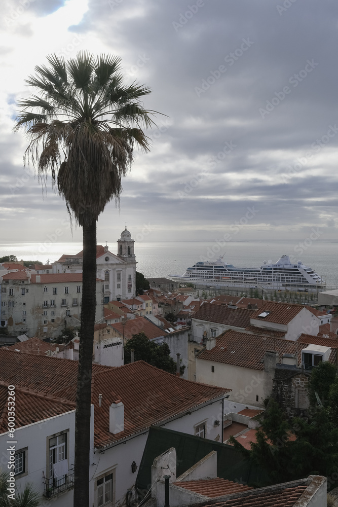 Luxury liner cruiseship cruise ship Sirena, Regatta, Insignia or Nautica in port of Lisbon, Portugal during Mediterranean cruising with city skyline